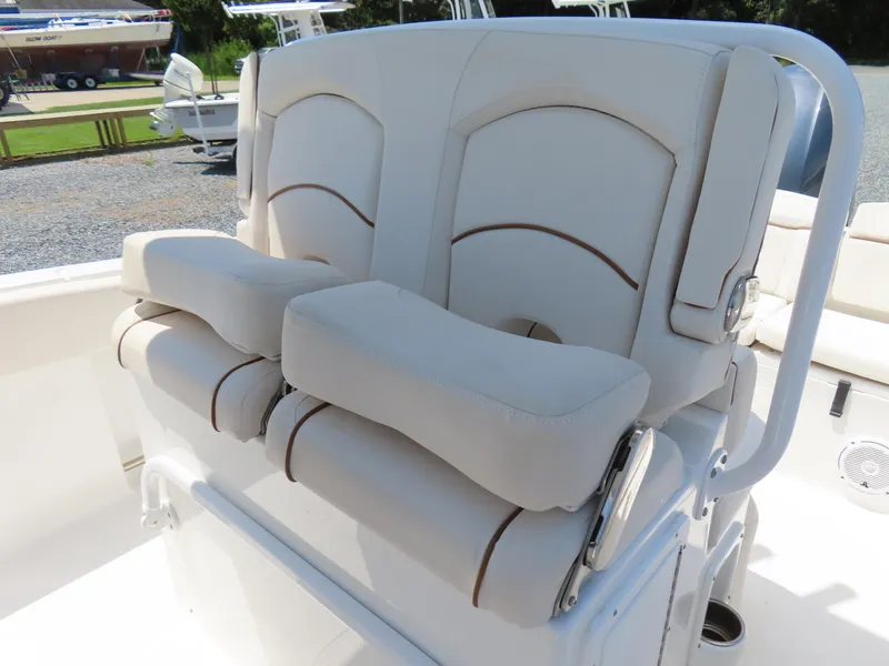 Slide: The Image of 2020 Sea Hunt Ultra 234 boat seating with cushioned armrests and white upholstery. - 22