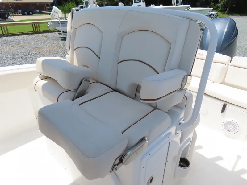 Slide: The Image of 2020 Sea Hunt Ultra 234 boat seating with white cushioned seats and armrests. - 23