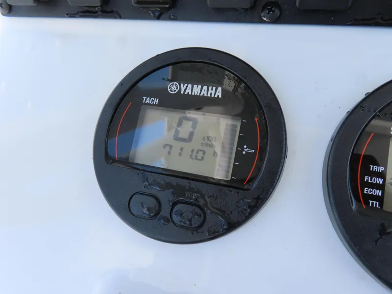 Slide: The Image of Yamaha tachometer on 2020 Sea Hunt Ultra 234 boat dashboard, displaying zero RPM. - 26