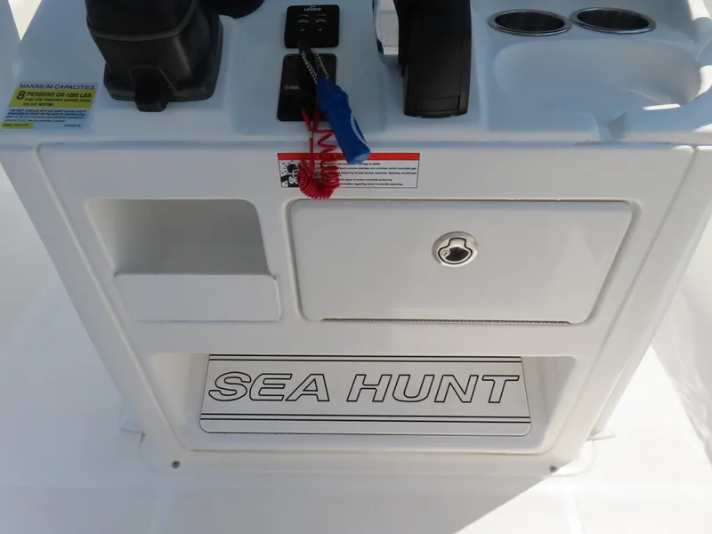 Slide: The Image of 2020 Sea Hunt Ultra 234 boat console with storage and controls. - 27