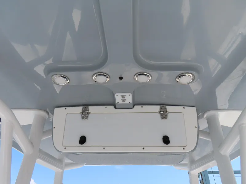 Slide: The Image of 2020 Sea Hunt Ultra 234 boat ceiling with lights and storage compartment. - 28