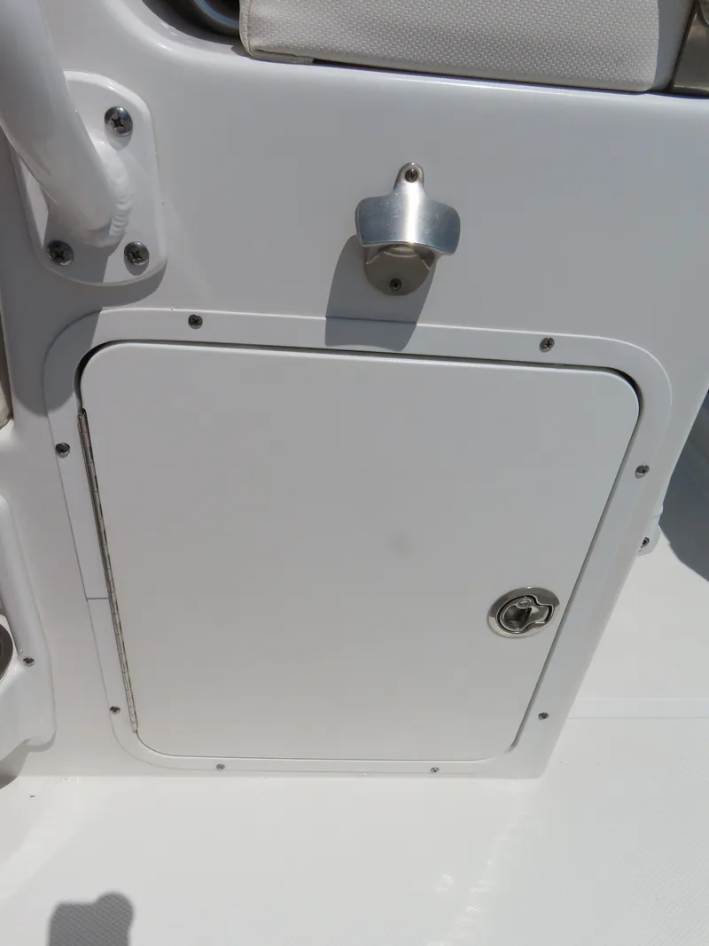Slide: The Image of 2020 Sea Hunt Ultra 234 boat storage compartment with latch and handle. - 30