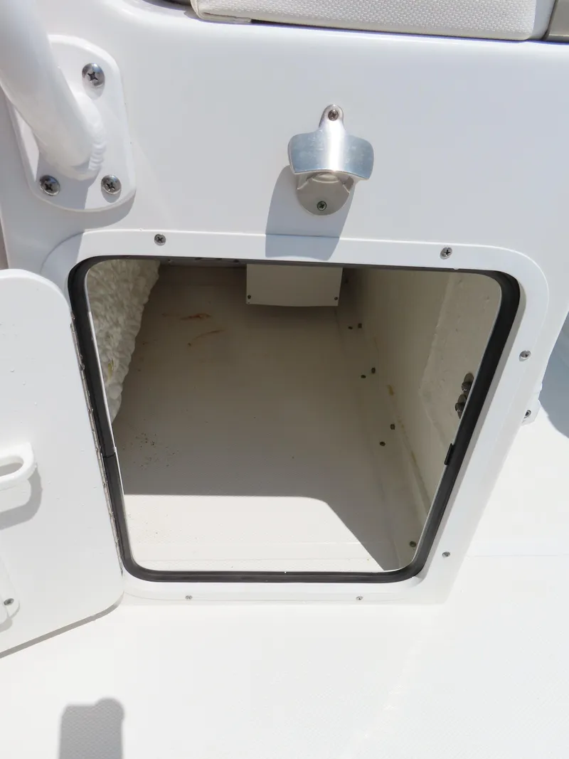 Slide: The Image of Storage compartment on a 2020 Sea Hunt Ultra 234 boat, open and empty. - 31