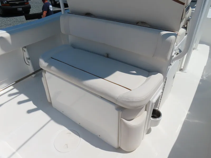 Slide: The Image of 2020 Sea Hunt Ultra 234 boat seating area with white cushioned bench. - 34