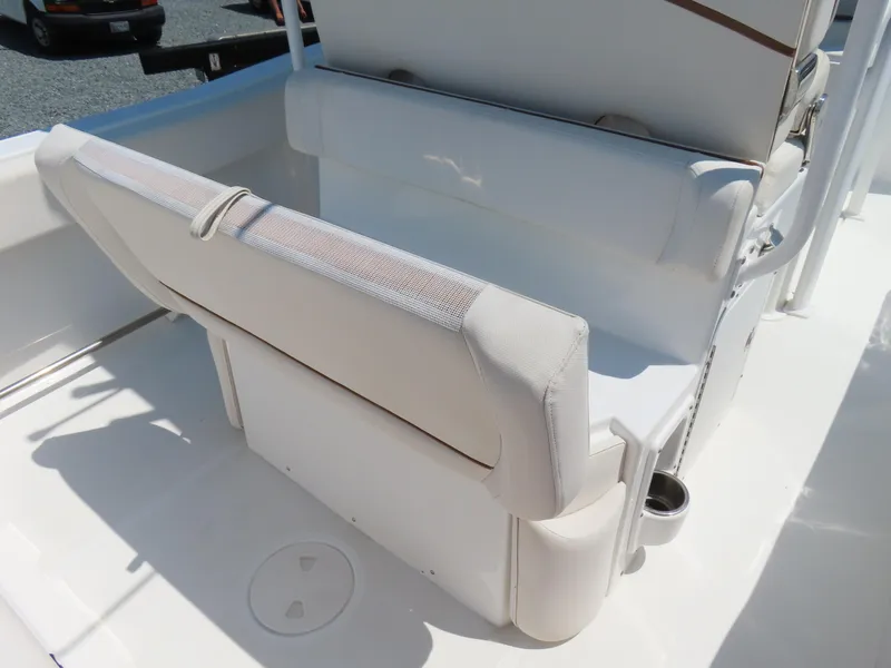 Slide: The Image of 2020 Sea Hunt Ultra 234 boat seating area with white upholstery and cup holder. - 35
