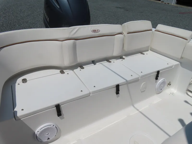 Slide: The Image of 2020 Sea Hunt Ultra 234 boat interior with cushioned seating and storage compartments. - 38
