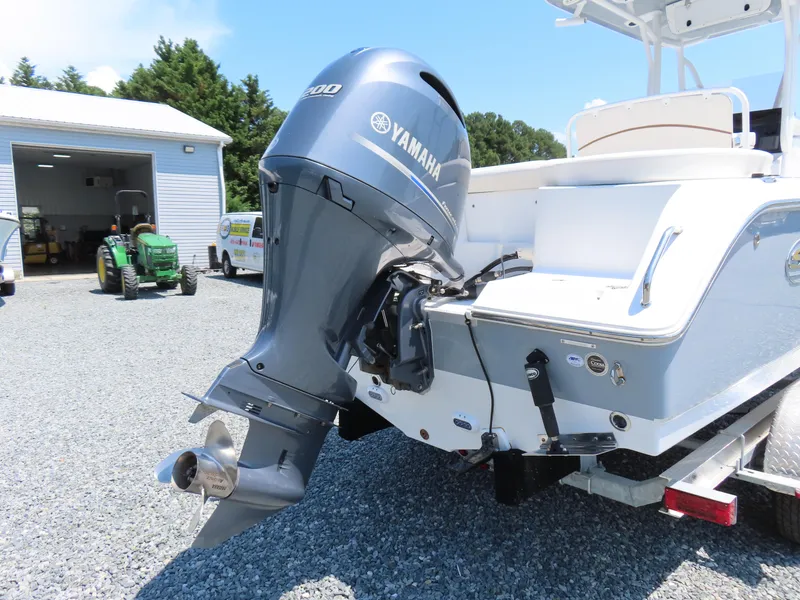 Slide: The Image of 2020 Sea Hunt Ultra 234 boat with Yamaha outboard motor, parked on gravel. - 4