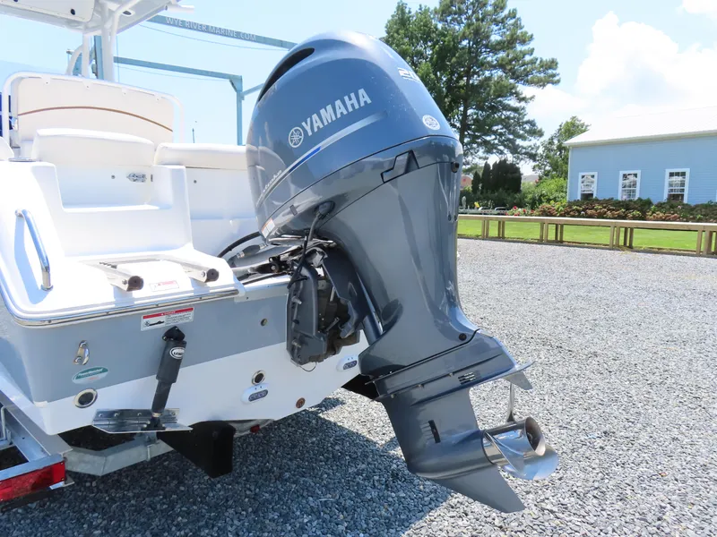 Slide: The Image of 2020 Sea Hunt Ultra 234 boat with Yamaha outboard motor, parked on gravel. - 5