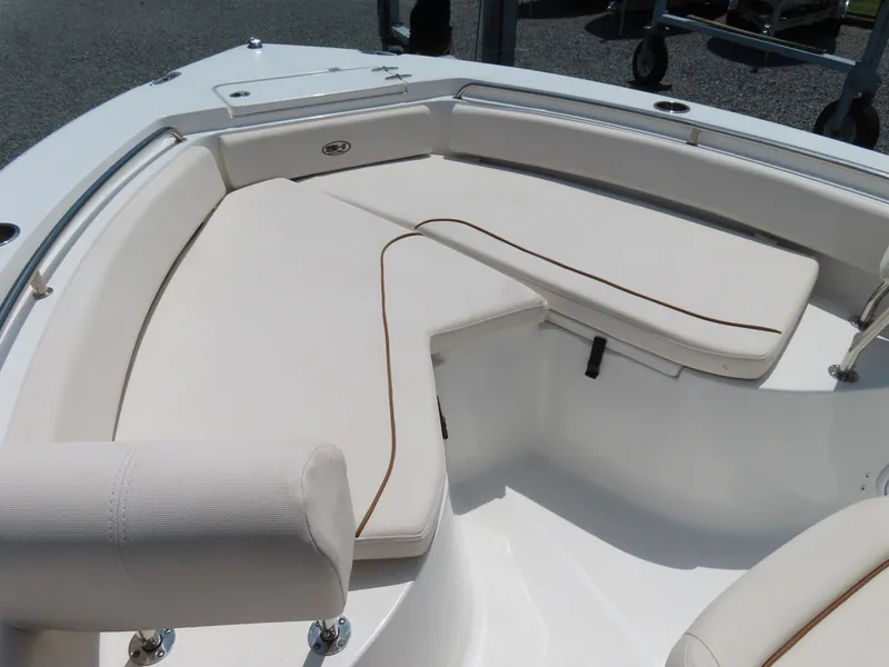 Slide: The Image of 2020 Sea Hunt Ultra 234 boat interior with cushioned seating and sleek design. - 7