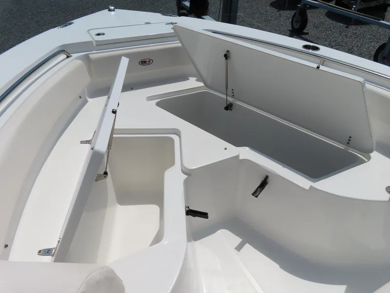 Slide: The Image of 2020 Sea Hunt Ultra 234 boat storage compartments open, showcasing spacious interior design. - 9