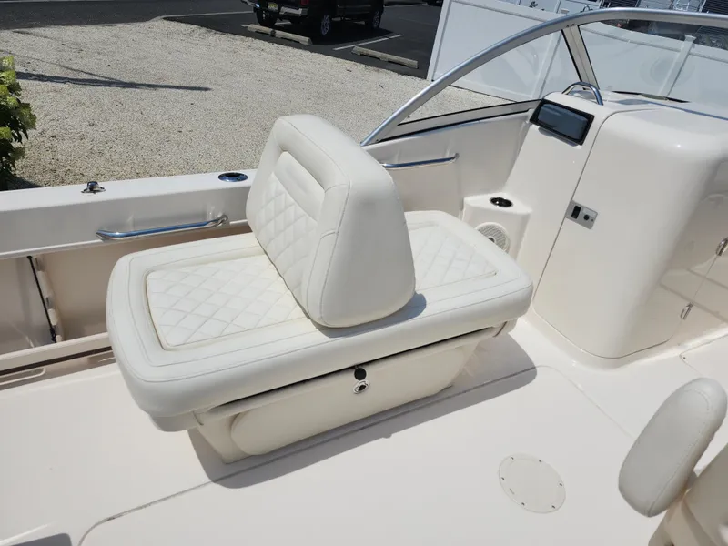 Slide: The Image of 2018 Grady-White Freedom 215 boat interior with white cushioned seating. - 11