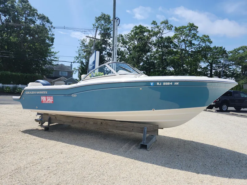 Slide: The Image of 2018 Grady-White Freedom 215 boat for sale, displayed outdoors on a sunny day. - 2