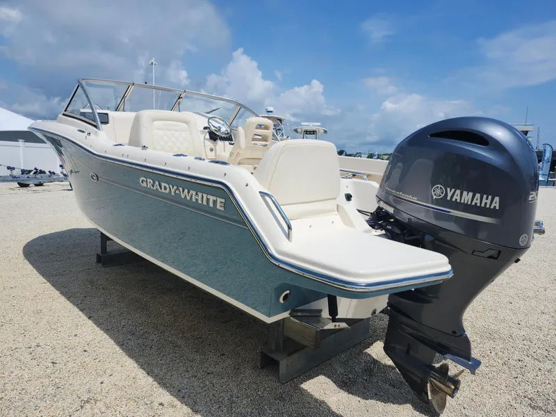 Slide: The Image of 2018 Grady-White Freedom 215 boat with Yamaha engine, displayed outdoors on gravel. - 4