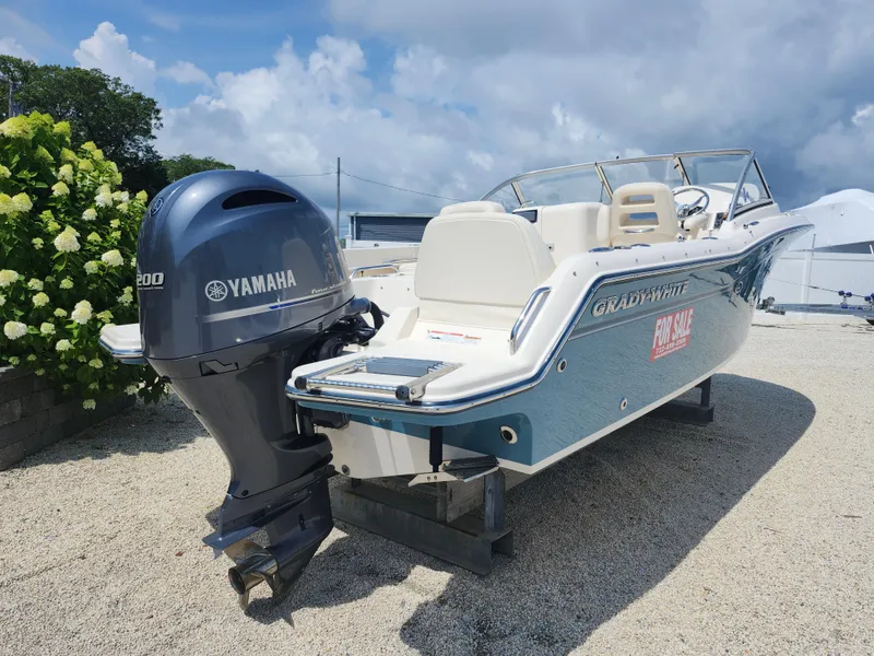 Slide: The Image of 2018 Grady-White Freedom 215 boat with Yamaha engine, for sale, parked on gravel. - 5