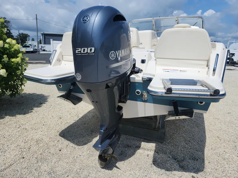 Slide: The Image of 2018 Grady-White Freedom 215 boat with Yamaha 200 engine, parked on gravel. - 6