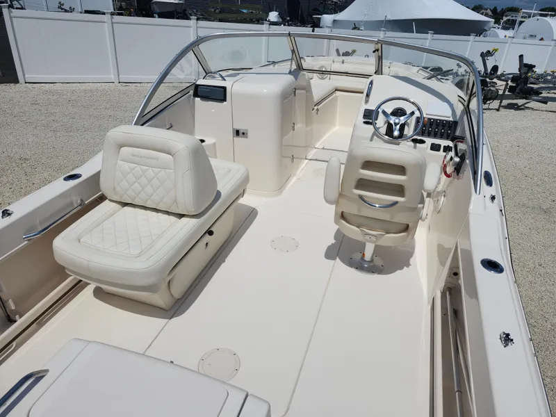 Slide: The Image of 2018 Grady-White Freedom 215 boat interior with seating and steering wheel. - 7