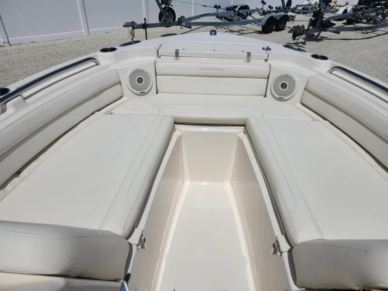 Slide: The Image of 2018 Grady-White Freedom 215 boat interior with white seating and speakers. - 9