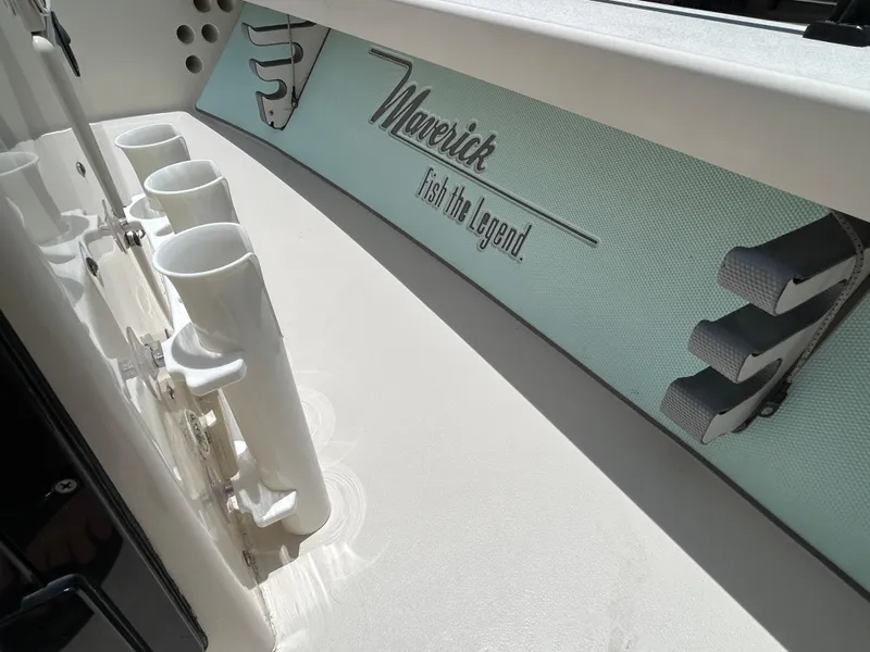 Slide: The Image of 2011 Maverick Mirage 17HPX-Tunnel boat interior with rod holders and branding. - 11