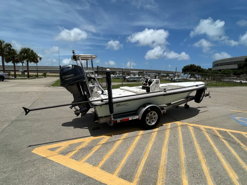 Slide: The Image of 2011 Maverick Mirage 17HPX-Tunnel boat on trailer, parked under a clear blue sky. - 2
