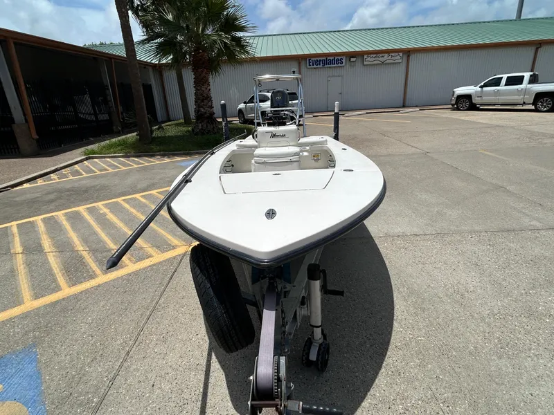 Slide: The Image of 2011 Maverick Mirage 17HPX-Tunnel boat on trailer, parked outside a building. - 5