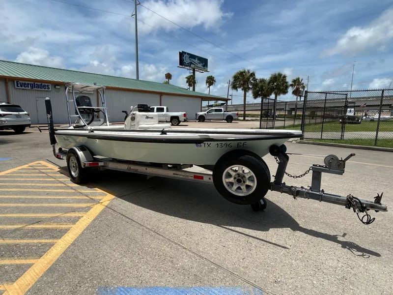 Slide: The Image of 2011 Maverick Mirage 17HPX-Tunnel boat on trailer, parked outdoors near Everglades building. - 6