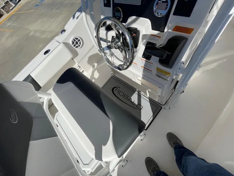 Slide: The Image of 2023 Robalo R202 Explorer boat interior with steering wheel and seating. - 10