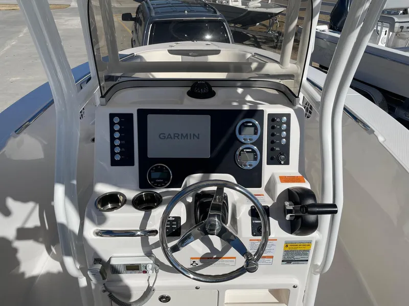 Slide: The Image of 2023 Robalo R202 Explorer boat dashboard with Garmin navigation system and controls. - 12
