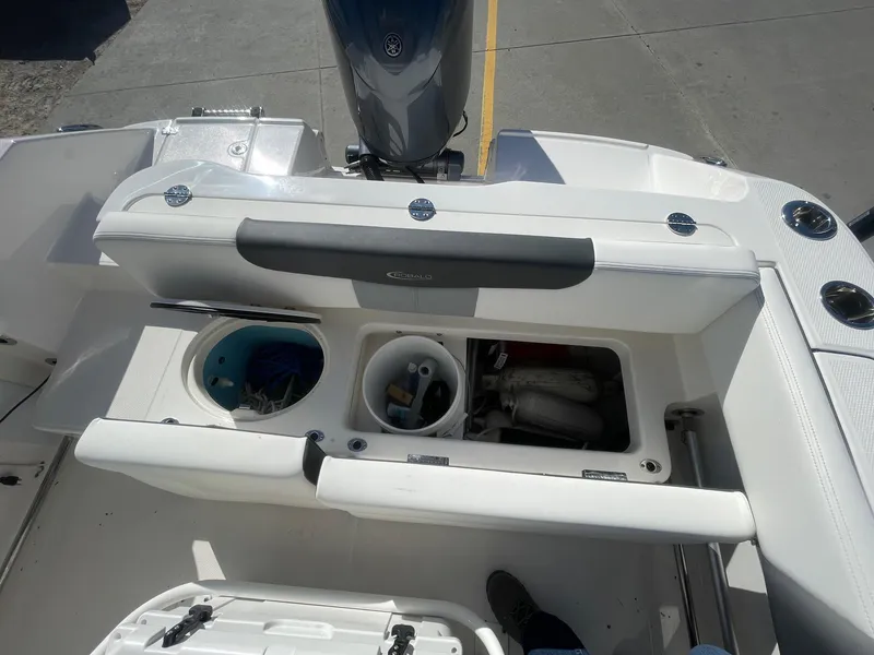 Slide: The Image of 2023 Robalo R202 Explorer boat storage compartments and seating area. - 3