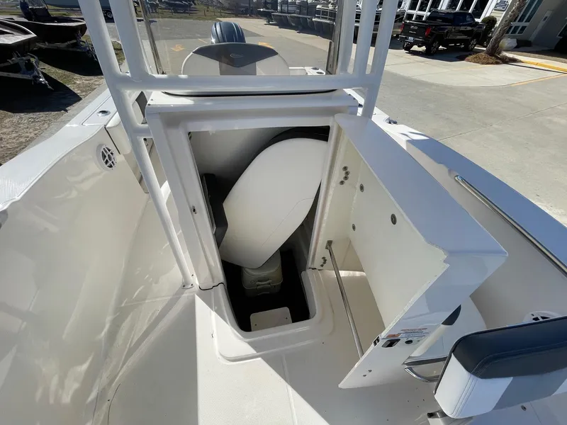 Slide: The Image of 2023 Robalo R202 Explorer boat with open storage compartment and seating area. - 4