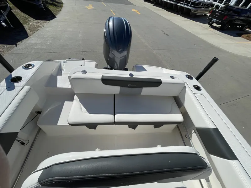 Slide: The Image of 2023 Robalo R202 Explorer boat interior with seating and outboard motor. - 9