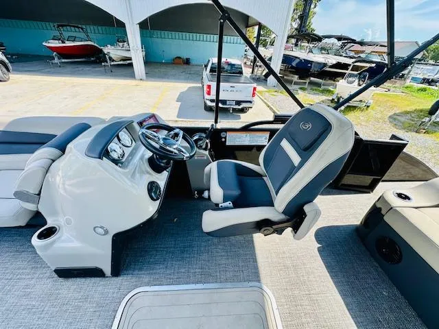 Slide: The Image of 2022 Barletta C24U boat interior with steering wheel and captain's chair. - 12