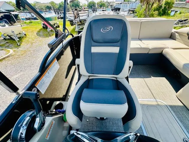 Slide: The Image of 2022 Barletta C24U boat interior with captain's chair and seating area. - 15