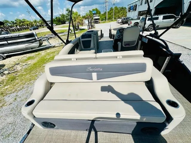 Slide: The Image of 2022 Barletta C24U pontoon boat interior with seating and steering console. - 20
