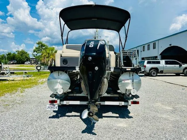 Slide: The Image of 2022 Barletta C24U pontoon boat with outboard motor on a trailer. - 3