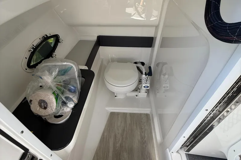 Slide: The Image of Interior of 2017 Formula 270 Bowrider boat bathroom with toilet and supplies. - 14