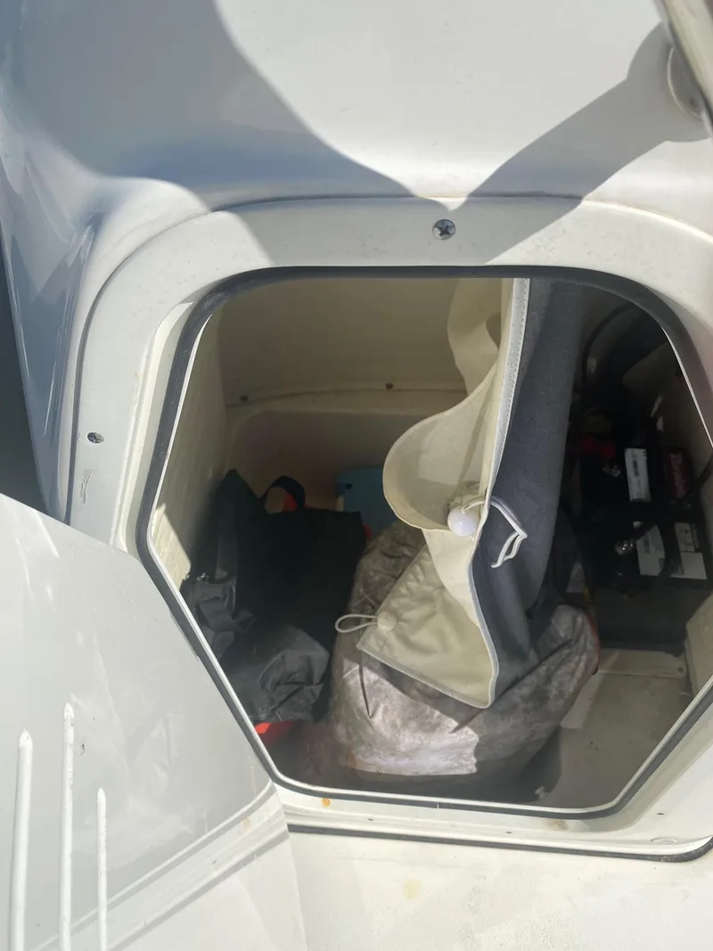 Slide: The Image of Storage compartment of 2023 Key West 189 FS boat, containing various items and equipment. - 5