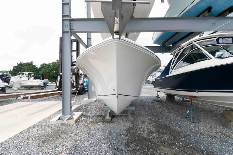 Slide: The Image of 2016 Sailfish 240 CC boat in storage, surrounded by other vessels. - 3