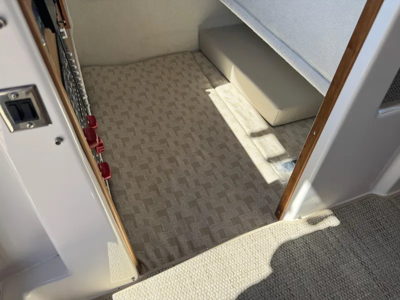 Slide: The Image of Interior view of 2025 Cutwater C-288 Coupe, featuring patterned flooring and seating area. - 21