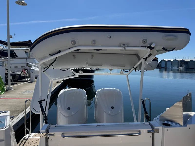 Slide: The Image of 2025 Cutwater C-288 Coupe boat docked, featuring dual engines and a sleek design. - 33