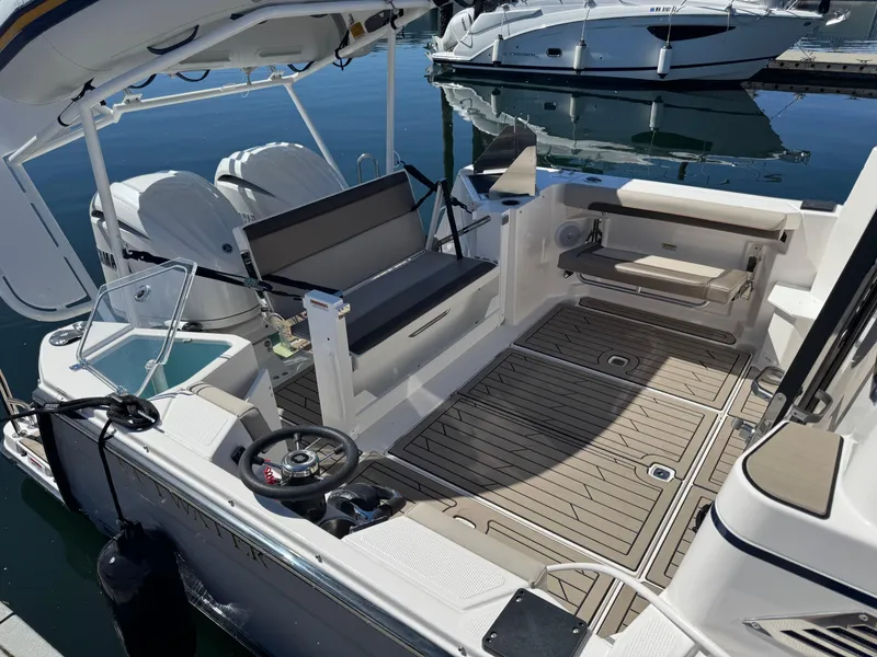 Slide: The Image of 2025 Cutwater C-288 Coupe boat interior with seating and dual engines at a marina. - 5