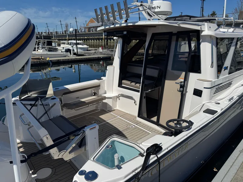 Slide: The Image of 2025 Cutwater C-288 Coupe docked, showcasing spacious deck and modern design. - 6