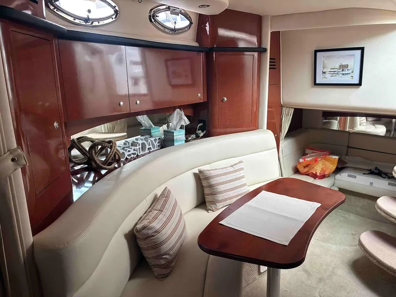Slide: The Image of Luxurious interior of a 2005 Sea Ray 320 Sundancer yacht with elegant seating and wooden cabinetry. - 10