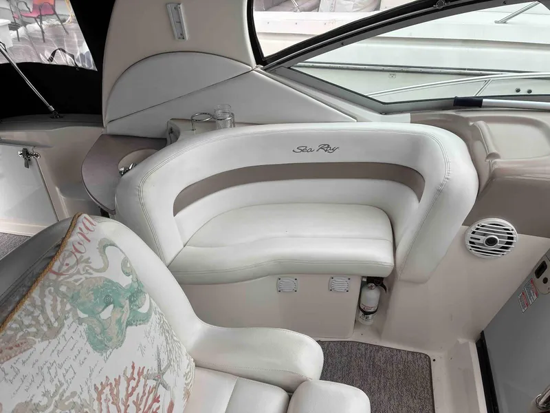 Slide: The Image of 2005 Sea Ray 320 Sundancer interior with white seating and decorative pillow. - 6