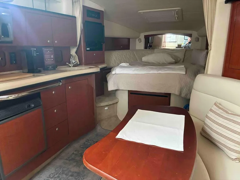 Slide: The Image of Interior of 2005 Sea Ray 320 Sundancer with cozy cabin and kitchenette. - 8