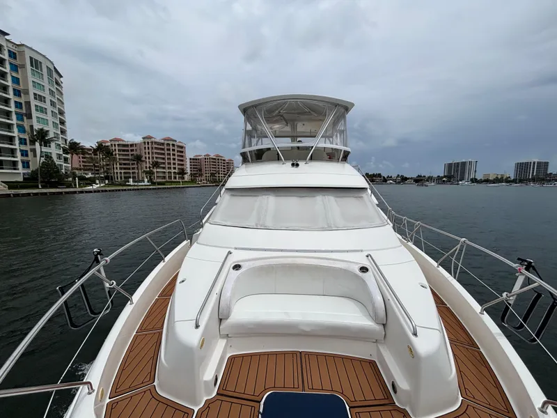 Slide: The Image of 2000 Silverton 453 Motor Yacht on water, surrounded by modern buildings. - 11
