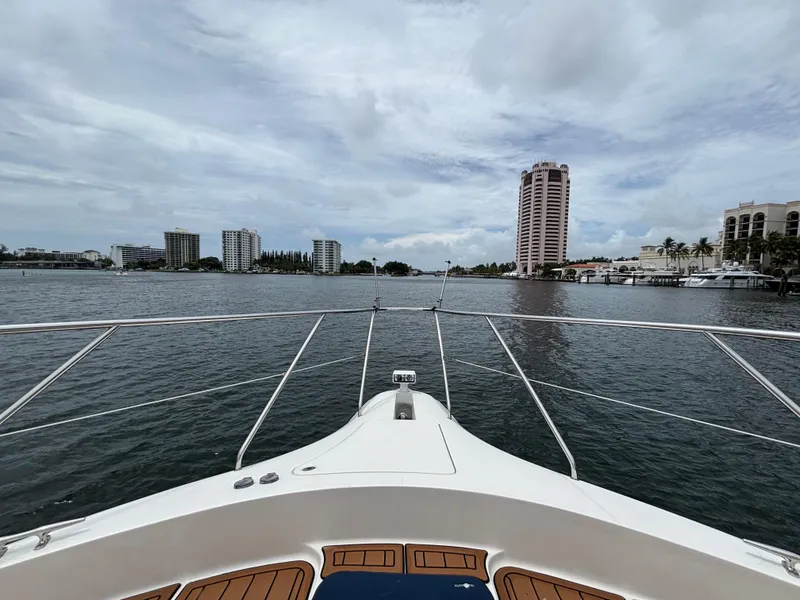 Slide: The Image of Bow view from 2000 Silverton 453 Motor Yacht, overlooking waterfront cityscape. - 13