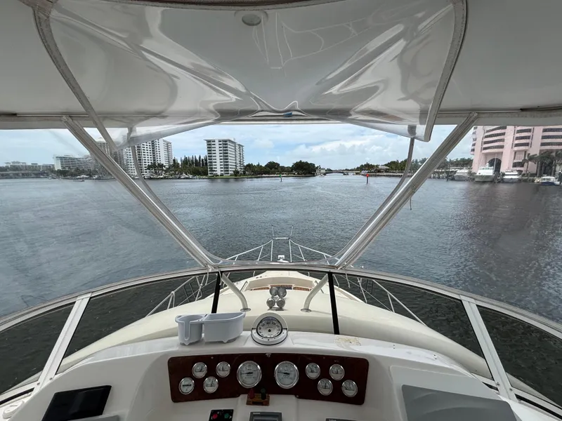 Slide: The Image of View from 2000 Silverton 453 Motor Yacht helm, overlooking a scenic waterfront with buildings. - 16