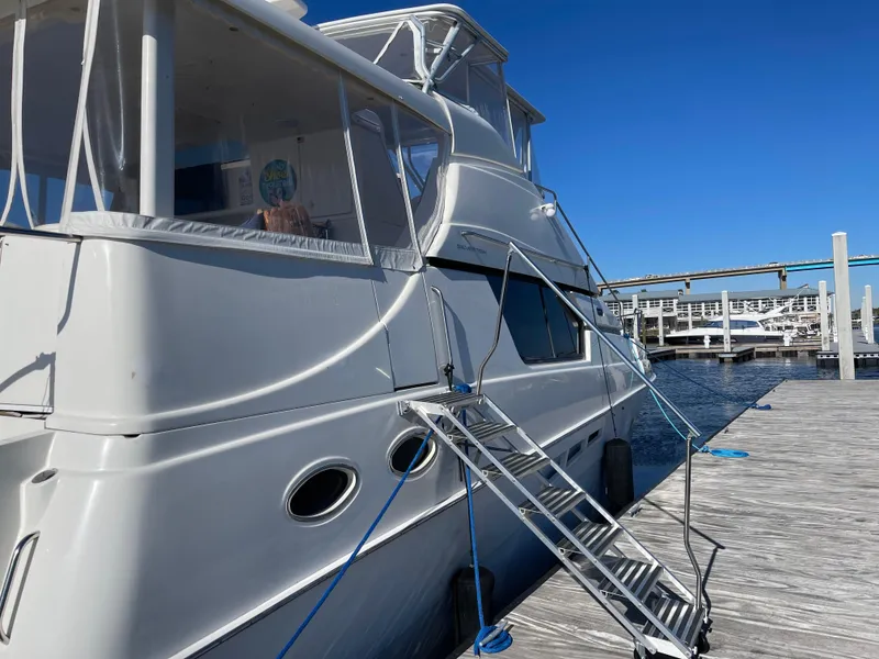 Slide: The Image of 2000 Silverton 453 Motor Yacht docked at marina with clear blue sky. - 19