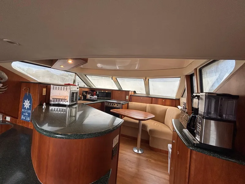 Slide: The Image of Interior of 2000 Silverton 453 Motor Yacht with kitchen and seating area. - 20