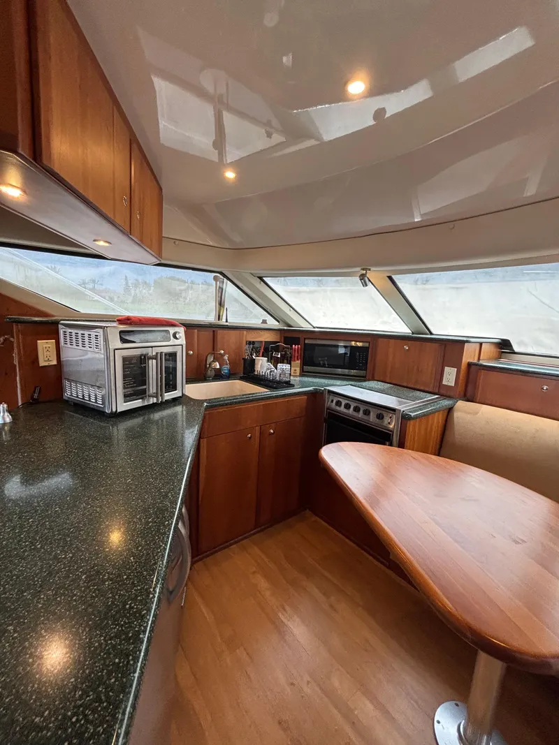 Slide: The Image of Interior of 2000 Silverton 453 Motor Yacht kitchen with modern appliances and wood finish. - 22